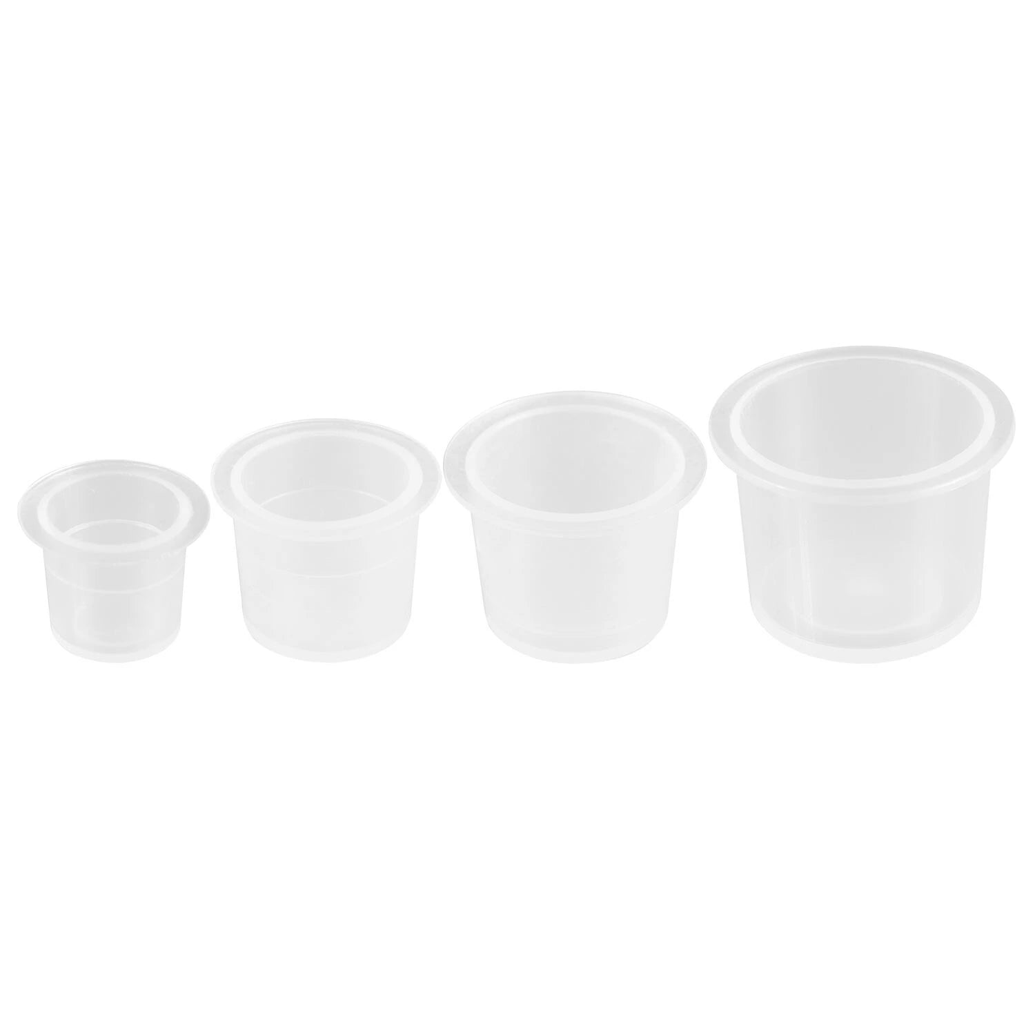Four small clear plastic tattoo ink cups on a white background
